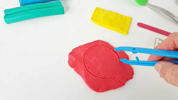 Draw shapes in clay with kids tongs or tweezers