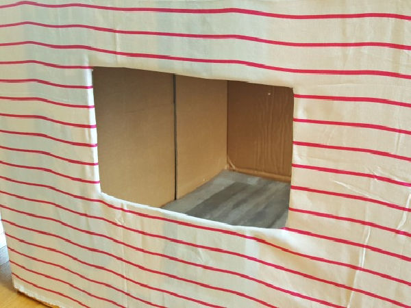Homemade play house from a cardboard box