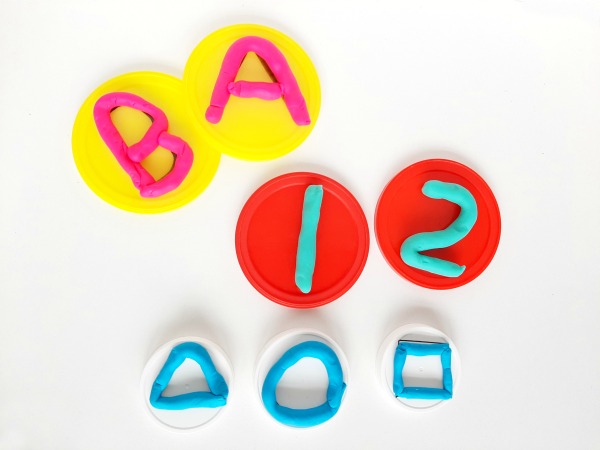 Make play dough mats with numbers or shapes from plastic lids