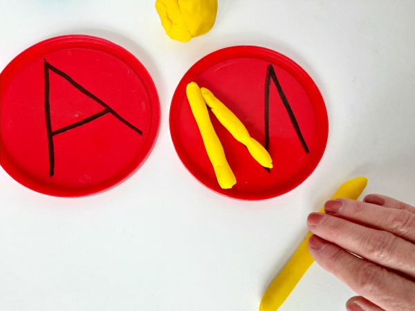 Roll play dough in strips to make letters