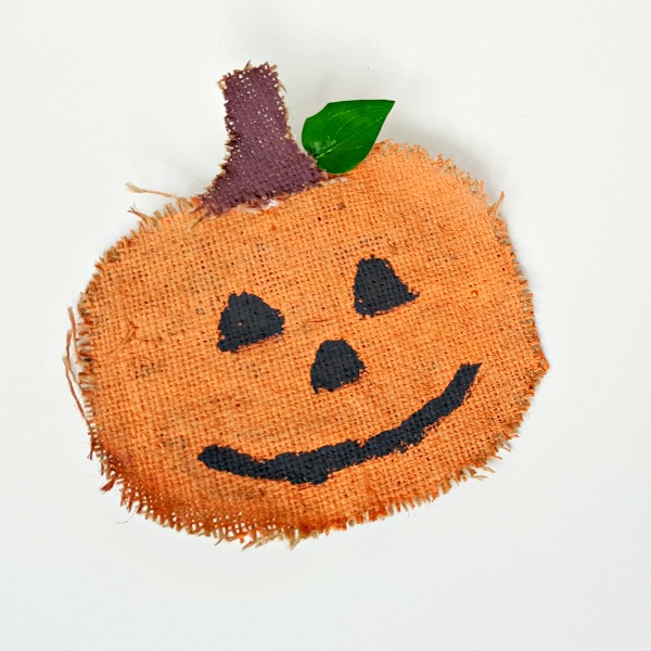 Autumn pumpkin craft for kids using burlap and orange paint