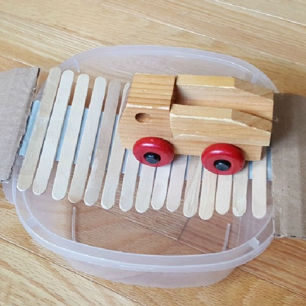 Bridge building STEM for kids using craft sticks