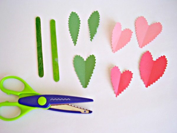 Cut paper with scalloped edge scissors to make petals and leaves