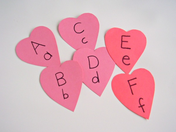 Cut valentine shapes from card stock to make alphabet cards for preschool literacy activities