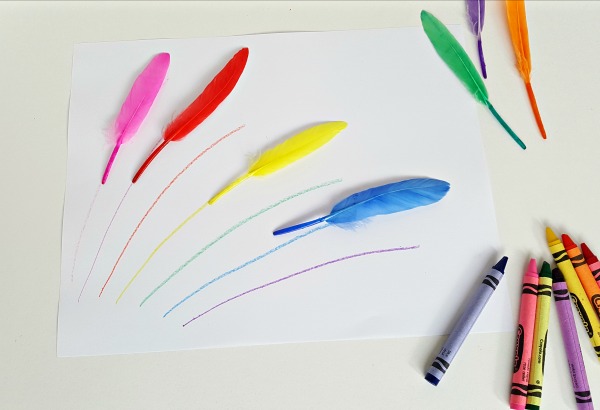 Feathers with crayons in a rainbow activity