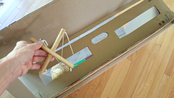 Operate marionette in a homemade puppet theater