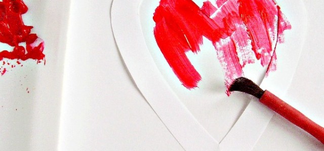 Painting with stencils in a Valentine themed activity for kids