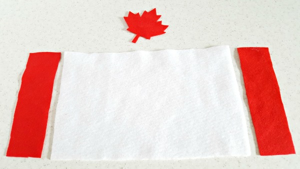 Red and white felt pieces to make a Canadian flag on the felt board