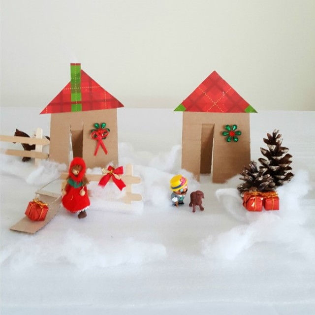 Winter small world play with cardboard houses and pine cone trees