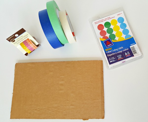 Supplies for preschool artwork activity include tape and dots