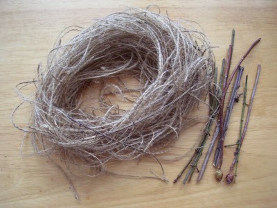 Bird nest craft with sticks and burlap fibers