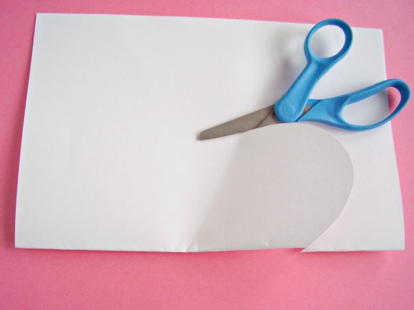 Cut a heart shape from folded sheet of paper