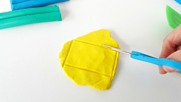 Cut shapes from clay with kids scissors