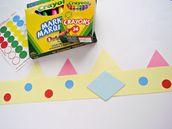 Decorate a paper crown with crayons and markers