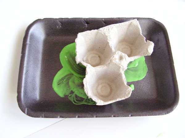 Dip egg cups into paint to make shamrock paintings