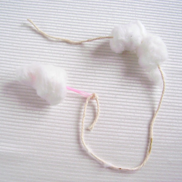 Lace cotton balls onto a length or yarn