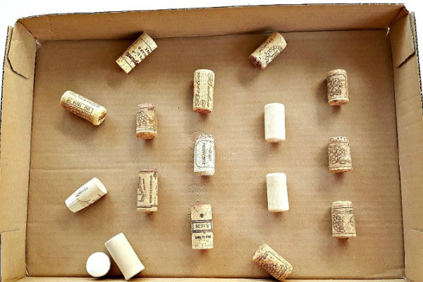 Make a maze in a cardboard box with recycled corks