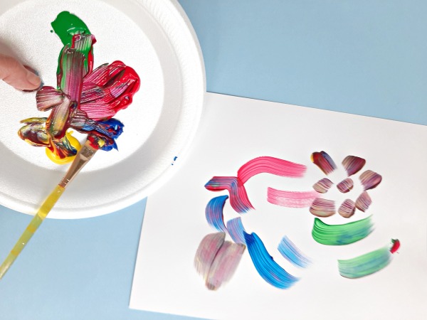 Mixing paint colors on a kids paint palette 