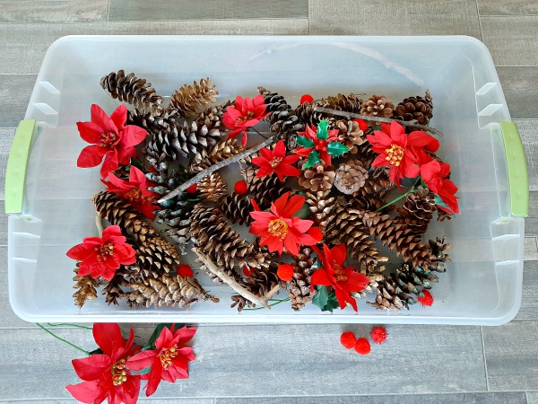 Sensory bin with pine cones and twigs