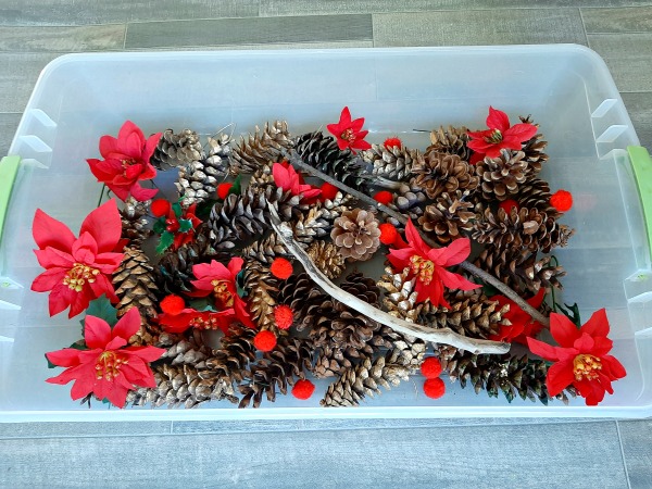 Kids sensory play with pine cones for Christmas