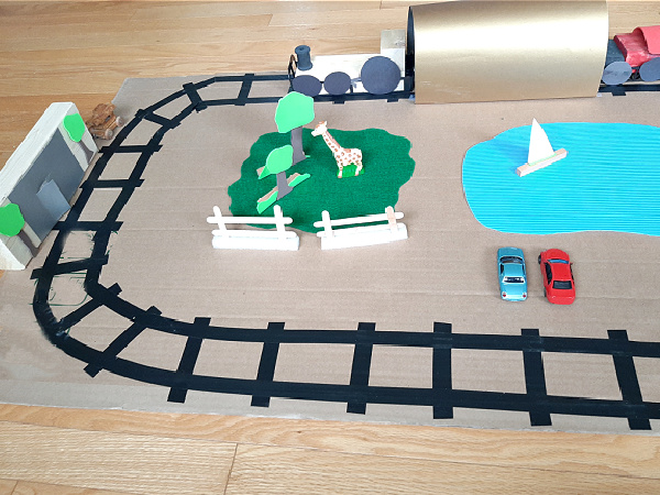 Add homemade props to small world train play for toddlers and preschoolers