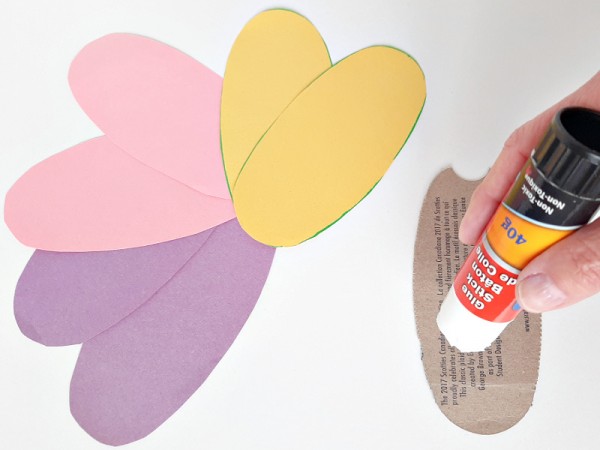Glue construction paper egg shapes to cardboard