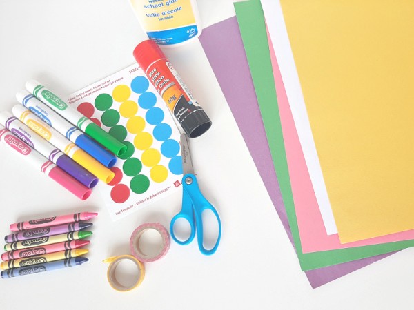 Cardboard Easter egg craft supplies include paper, crayons and stickers