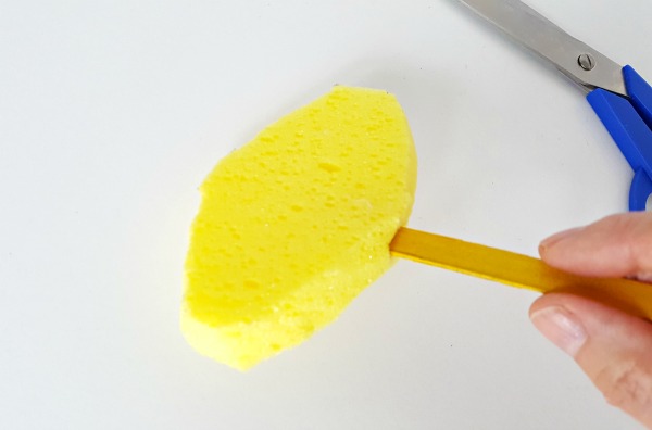 Add craft stick to sponge puppet