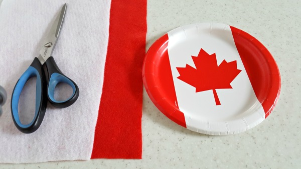 Cut a maple leaf from a Canada Day themed paper plate