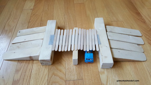 Craft stick bridge craft with ramps and toy cars