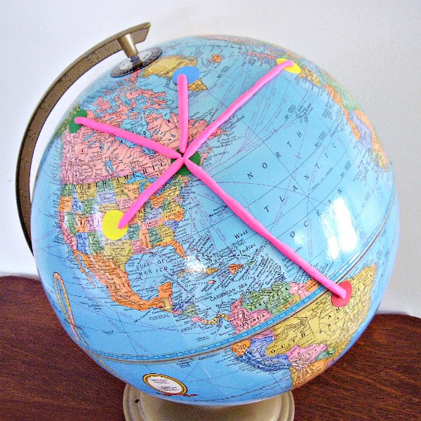 Earth day activity with a globe and modeling clay and colorful stickers for preschoolers