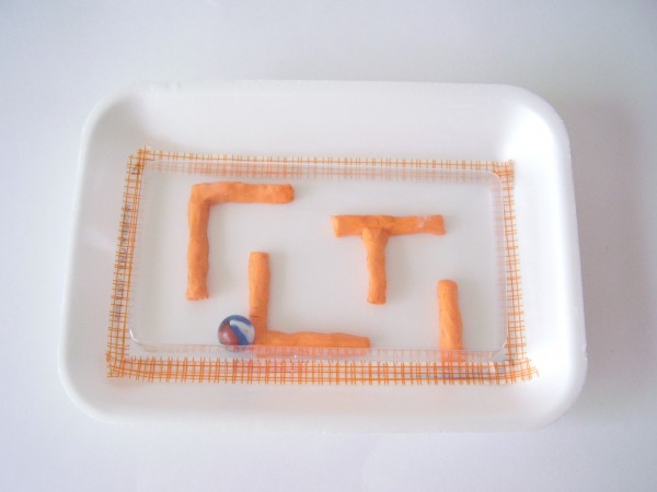Marble maze for kids to make using modeling clay