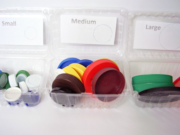 Sort jar lids by size in a preschool math activity