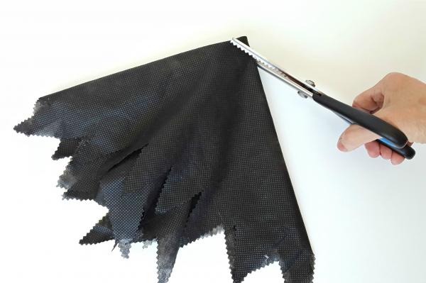 Trim black fabric with pinking shears to make a costume for a witch puppet