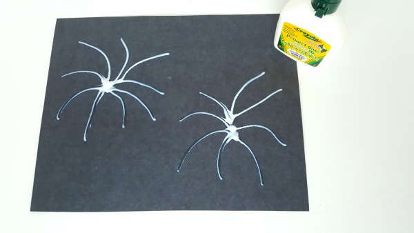 Apply glue to paper to resemble fireworks pattern