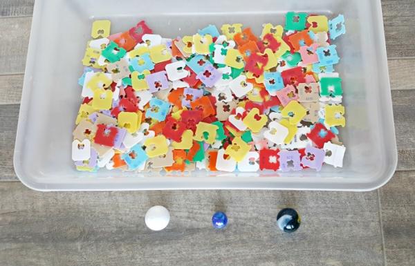 collect bread ties for a kids sensory bin activity with a marble