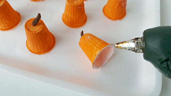 Glue mini pumpkins to foam plate