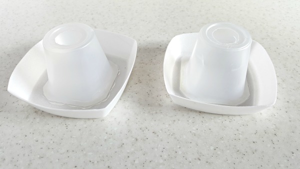 glue yogurt container to foam dishes to make mini volcano