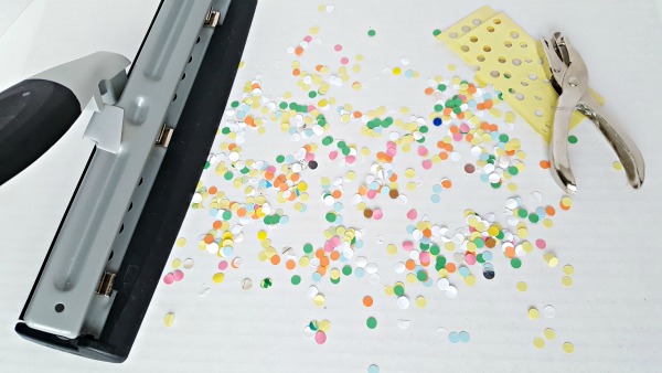 Make confetti by hole punching paper