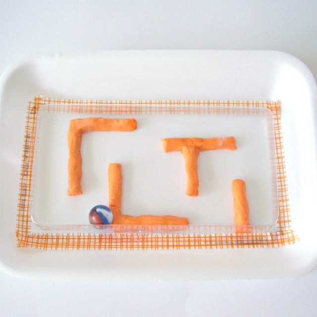 marble maze kids activity with a foam tray and clay