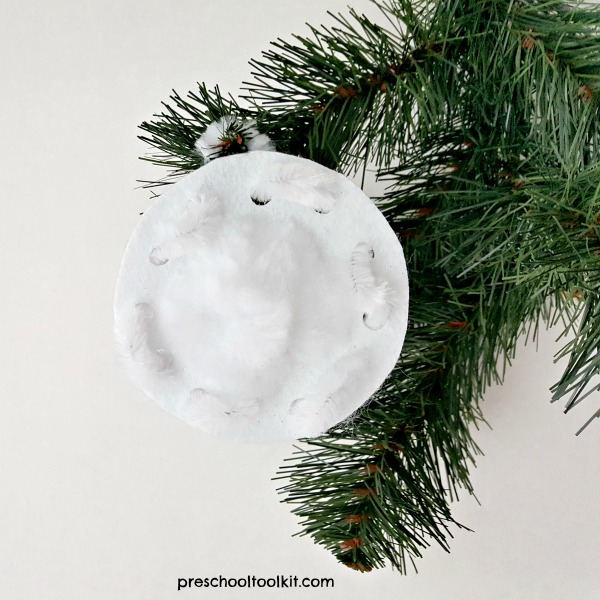 Kids can make a snowball ornament with craft foam and chenille stem