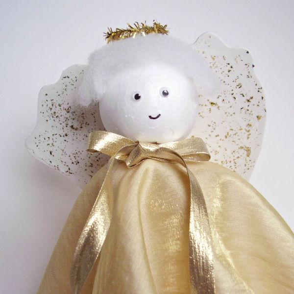 angel craft with glitter wings and fabric gown