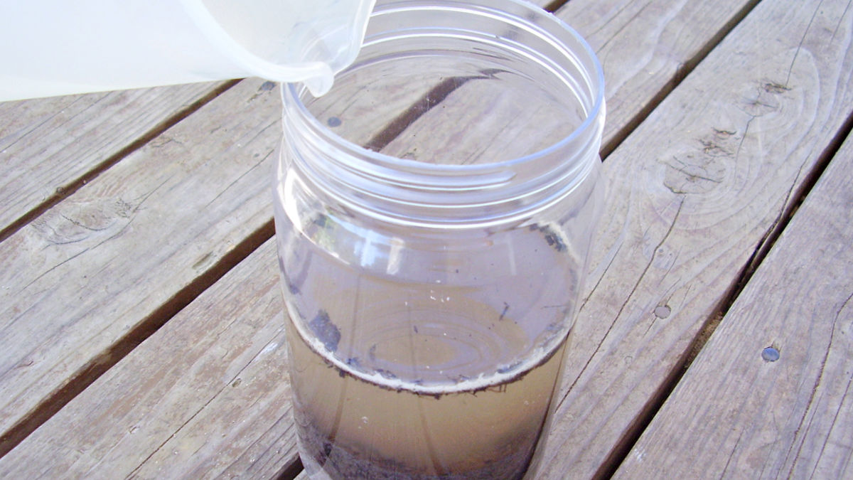 mix earth materials in a jar for science activity with preschoolers