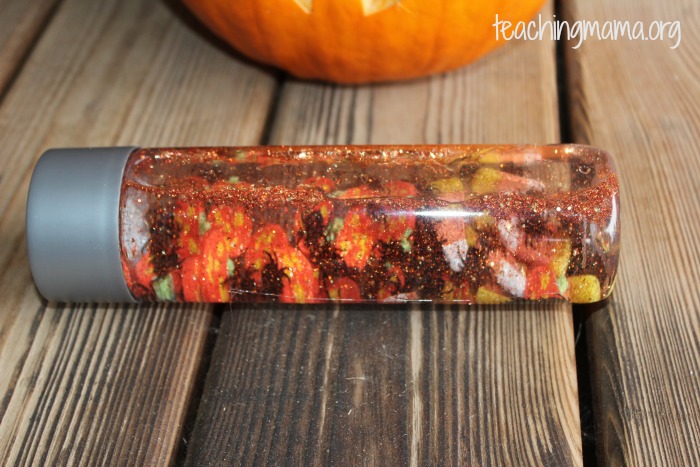 fill a sensory bottle with fall theme items for a kids activity