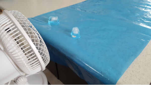 experiment with different surfaces for movement of ice cubes
