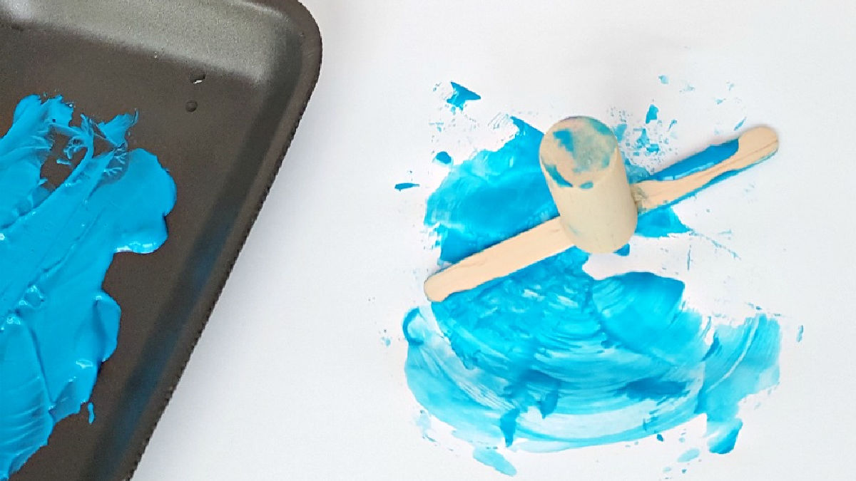 preschool art activities with a homemade craft stick paint tool