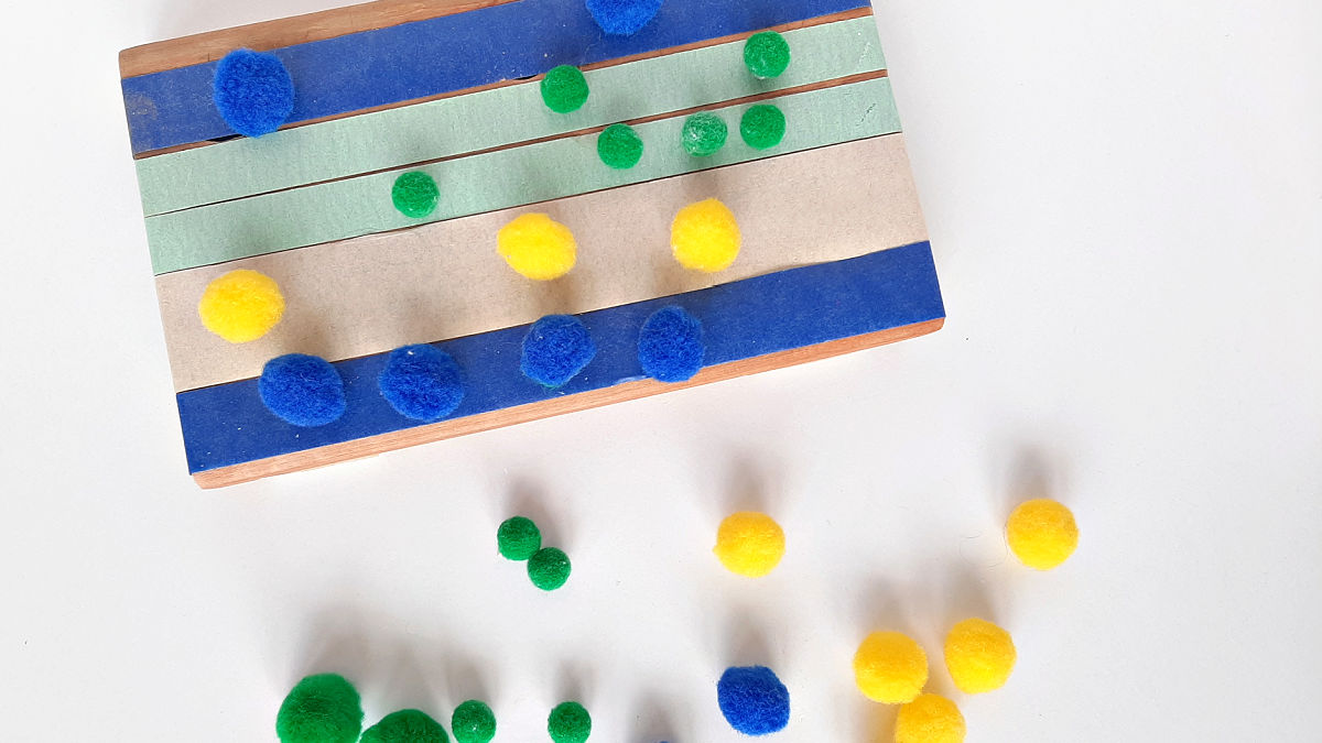 preschool math sorting pompoms on sticky tape