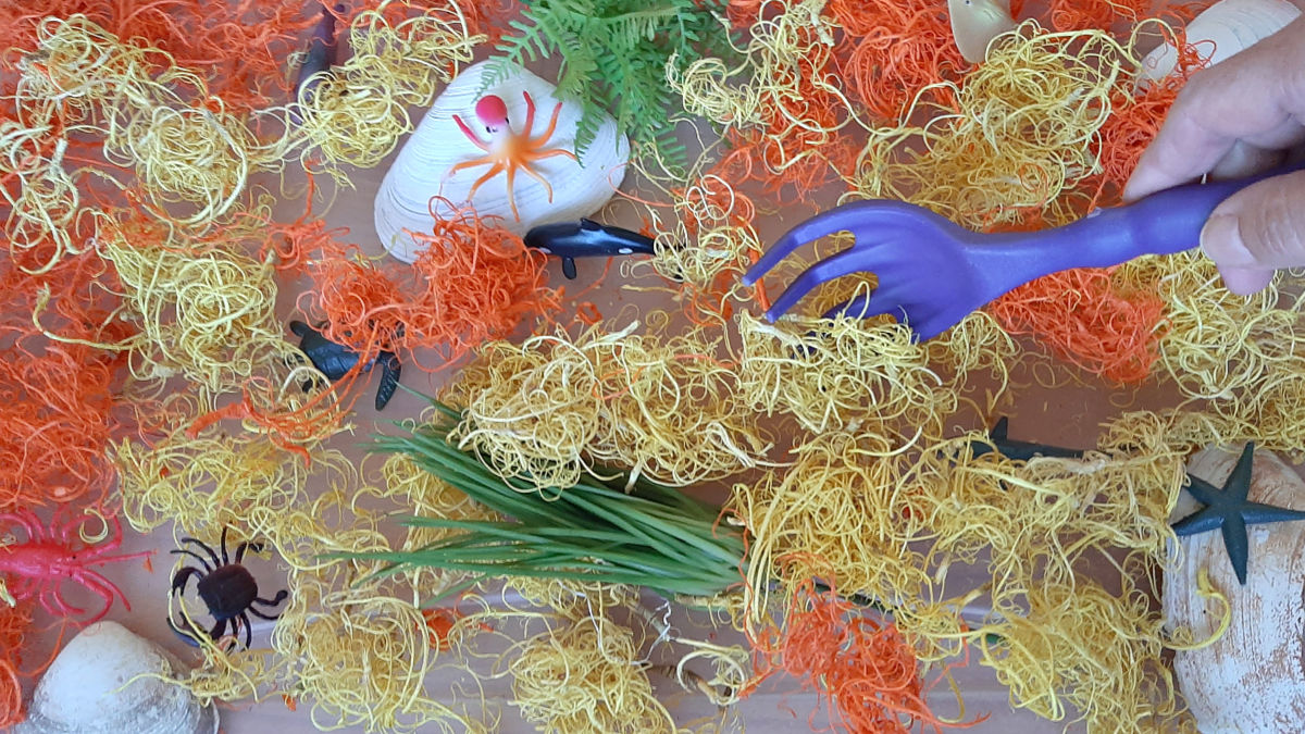 artificial sea moss and ocean animals for a sensory bin activity