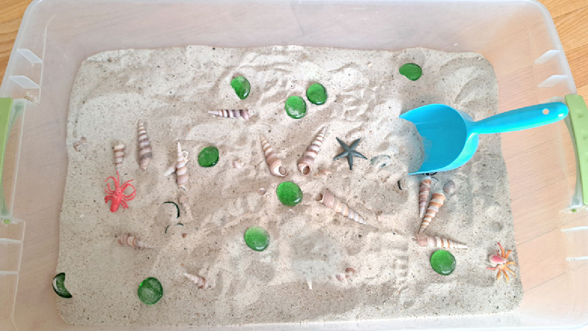 play sand sensory bin for beach day theme in preschool