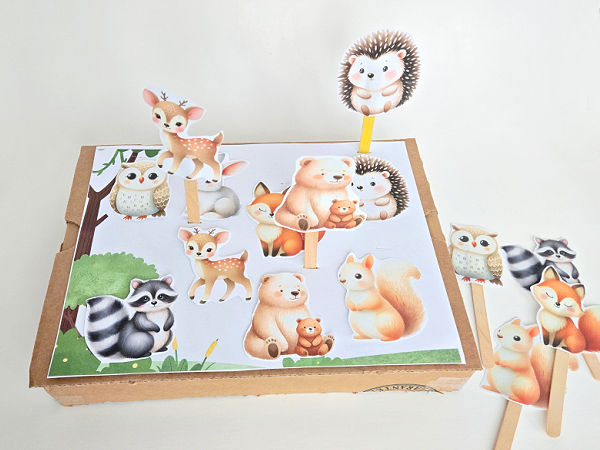 woodland animal cutouts taped onto craft sticks to make puppets